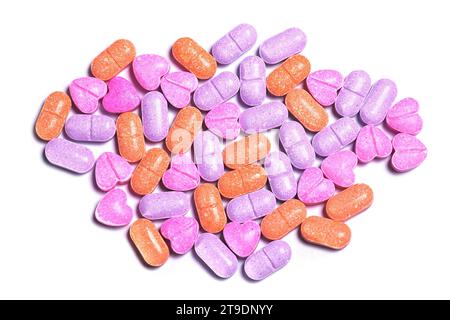 Closeup shot of a pile of colorful vitamin pills on white background. Stock Photo