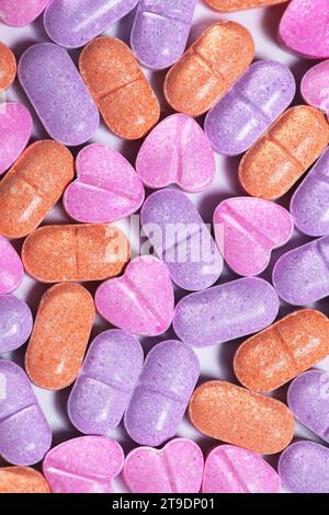 Closeup shot of a pile of bright colorful vitamin 'C' pills. Stock Photo