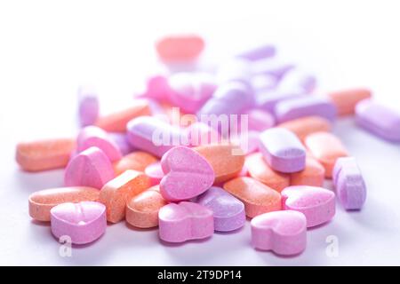 Closeup shot of a pile of colorful vitamin pills on white background. Stock Photo