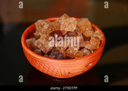 Cubes of organic palm tree rock sugar in a bowl on a black background Stock Photo