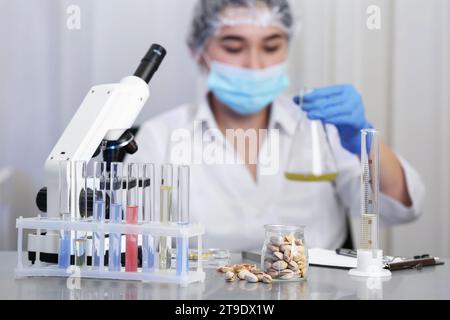 Pistachios on table and scientist proceeding quality control in laboratory Stock Photo