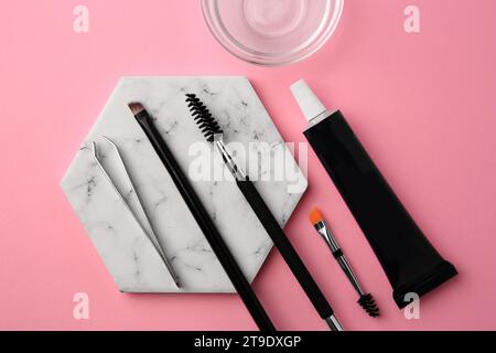 Flat lay composition with eyebrow henna and tools on pink background Stock Photo