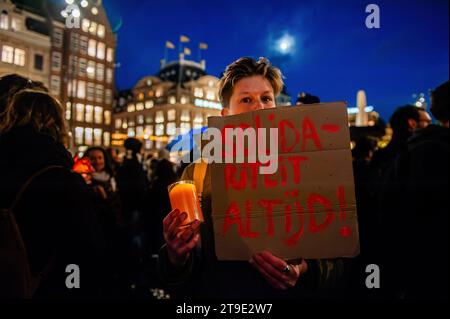 A protester holds a placard that says 'solidarity always' during the demonstration. Protesters stage a rally in solidarity with Muslims and immigrants following the victory of the far-right political party PVV (Party from Freedom under far-right leader Geert Wilders) in the general election. Protesters rally against Wilder's ideas, which have put certain groups like Muslims and immigrants at high risk. Wilders will still need other parties to join him in a coalition to govern with majority support in parliament. (Photo by Ana Fernandez/SOPA Images/Sipa USA) Stock Photo
