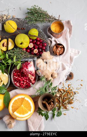 Variety of immunity boosting foods. Flat-lay of ginger, turmeric,  citrus fruit, herbs, garlic on a white background, top view. Healthy, vegan virus d Stock Photo