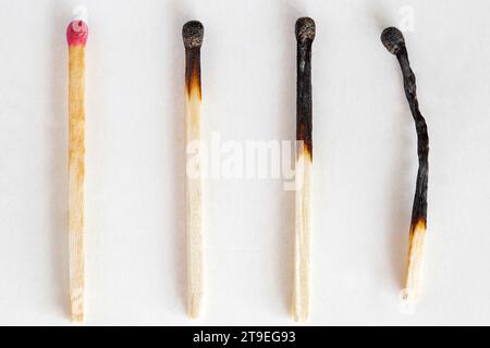 Matches, one whole and three burnt, macro close-up Stock Photo