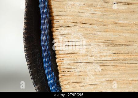 Book old, side is folded sheets, binding is rag close-up macro view Stock Photo