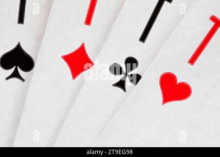 Playing cards ace of hearts, spades, diamonds, clubs, spread out in fan, close-up macro view Stock Photo