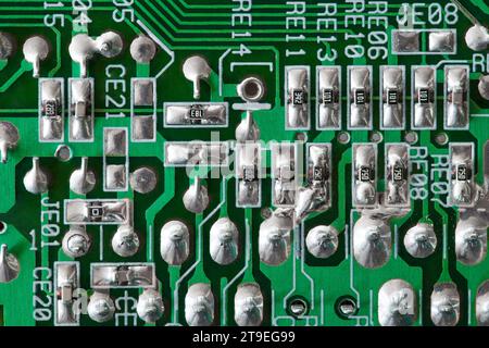 Electronic printed circuit board green with spot soldering, macro close-up Stock Photo