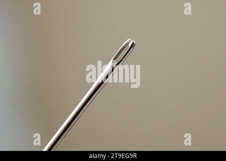 Sewing needle tailor, eyelet hole close-up macro view Stock Photo