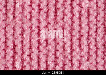 Knitted yarn made of pink wool threads, background structure, close-up macro view Stock Photo