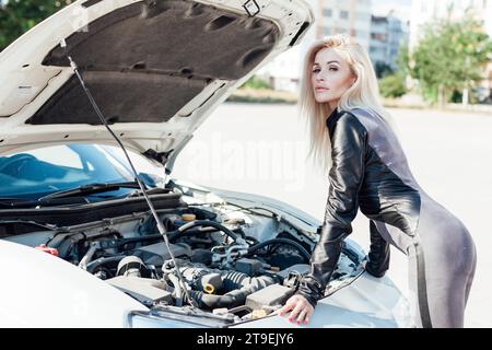 Woman car mechanic repairing engine Stock Photo