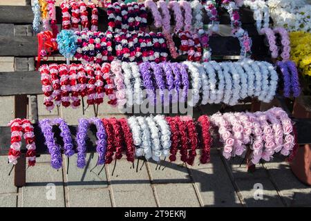 Colorful crowns for sale made of fake flowers Stock Photo