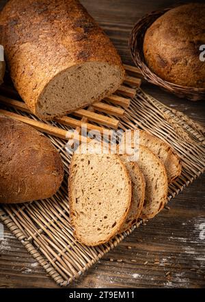 Slices of baked bread, sourdough bread on wooden background Stock Photo