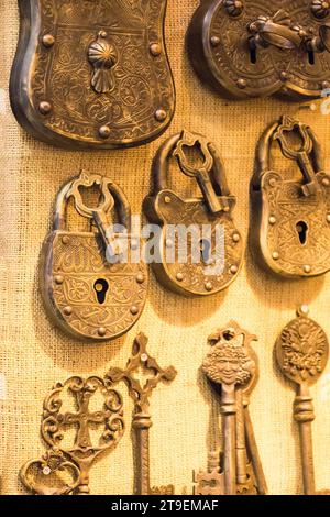 Retro styled keys and locks are hanging on a wall Stock Photo