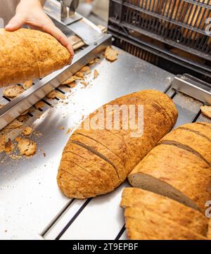 Bread slicer machine in bakery production line Stock Photo