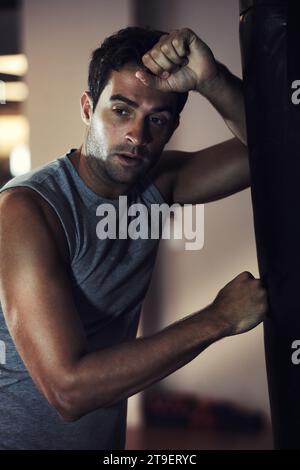 Fitness, athlete and tired man after boxing class with rest for break during exercise workout. Health, wellness and male person with fatigue on a Stock Photo