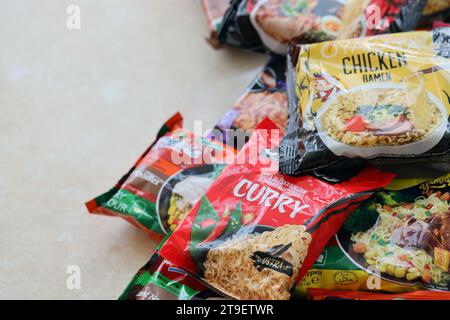 KYIV, UKRAINE - OCTOBER 31, 2023 Many packs of instant noodles for fast cooking by various brands and manufacturers close up Stock Photo