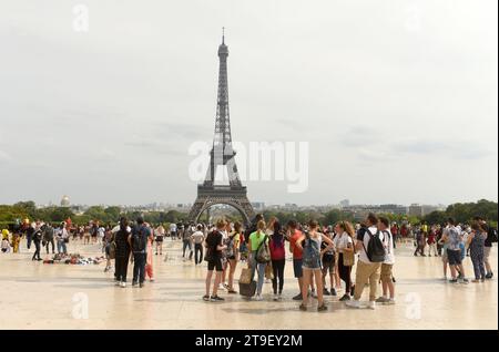 Paris, France - August 28, 2019: A crowd of people on Trocadero near the Eiffel Tower in Paris. Stock Photo