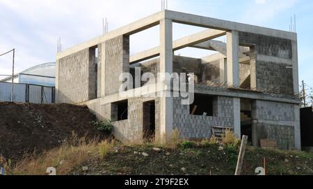 box of a two-story cottage under construction without a roof, a block building at the stage of erecting walls, construction of a residential building Stock Photo