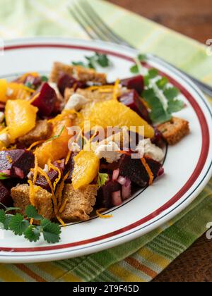 Beet and rye bread panzanella with oranges and home made vegan feta Stock Photo