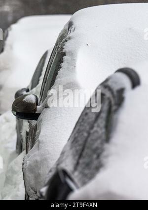 Oberwiesenthal, Germany. 25th Nov, 2023. Cars covered in snow on the roadside. There was fresh snow in the Erzgebirge during the night. Credit: Kristin Schmidt/dpa/Alamy Live News Stock Photo