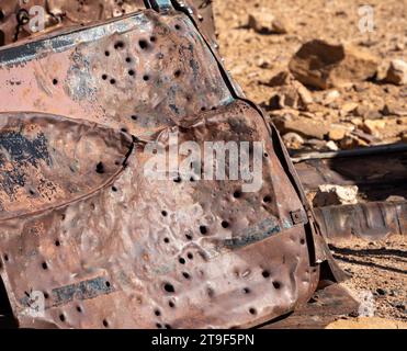 Abandoned Rusted Car with Bullet Holes in Desert Field Stock Photo - Alamy