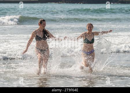 Two bikini clad women have fun in the sea at the Warren Beach, Rosscarbery, West Cork, Ireland. Stock Photo