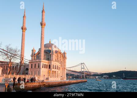 The Ortakoy Mosque in Istanbul with the bridge across the Bosphorus during the sunset Stock Photo