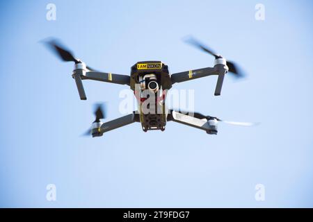 Surveillance drone or unmanned aerial vehicle UAV with camera and camcorder video record flying in sunflower garden park field at Saraburi and Lopburi Stock Photo