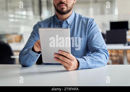 Busy young business man manager using tablet computer, close up. Stock Photo