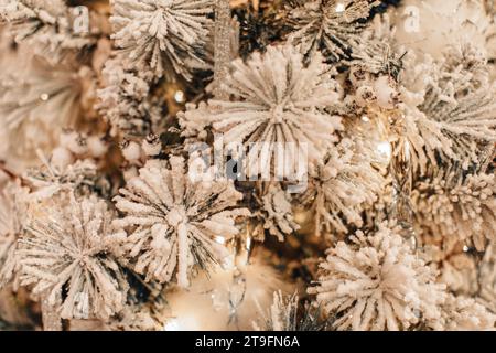 White Christmas background, snow covered Christmas tree branches, decorated with snowflakes. Festive details Stock Photo