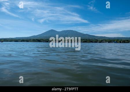 La Union, La Union, El Salvador - November 30, 2022: Coastline Seen From Afar with a Volcanic Mountain, Lush Vegetation Forest, Beach and Houses with Stock Photo