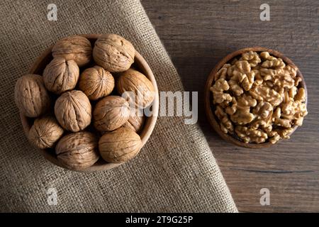 A bowl of shelled walnuts and a group of peeled walnuts, fresh walnuts Stock Photo
