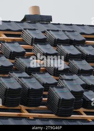 Roof building. Roofing finishing. Construction of unfinished house made of bricks, wood and timber.  Building site. Home building. Stock Photo