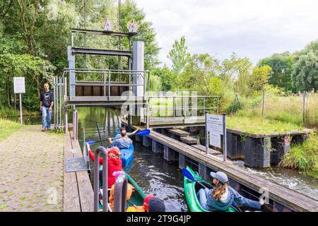 Burg, Germany - July 22, 2023: Passing sluice during canoe trip in Spreewald Venice of Germany with lots of canals and water pleasure between Dresden and Berlin in Brandenburg state in Germany Stock Photo