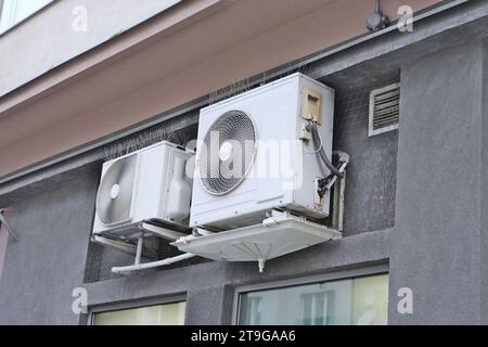 Large white old city air conditioner made of white aluminum sheet outside the building, vintage outdoor air conditioner, temperature control inside Stock Photo