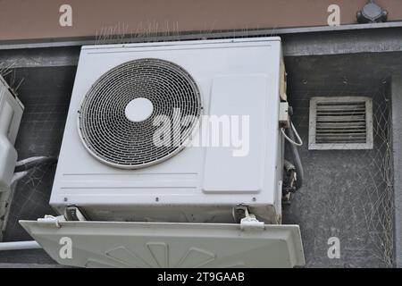 Large white old city air conditioner made of white aluminum sheet outside the building, vintage outdoor air conditioner, temperature control inside Stock Photo