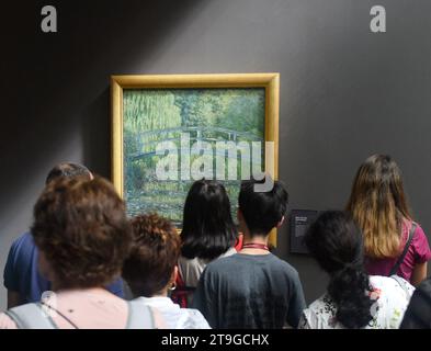 Paris, France - August 29, 2019: Crowd of visitors near the Water-Lily Pond, Symphony in Green 1899 by Claude Monet painting in Museum d'Orsay in Pari Stock Photo