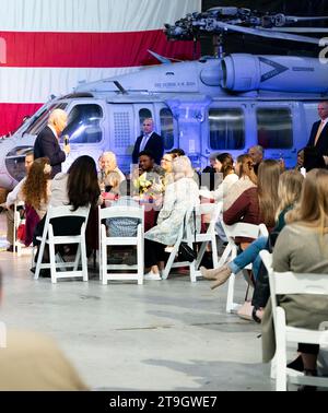 Norfork, United States of America. 19 November, 2023. U.S. President Joe Biden, left, delivers remarks after serving Thanksgiving to members of the armed forces and their families during a Friendsgiving dinner at Naval Station Norfolk, November 19, 2023 in Washington, D.C. The meal was hosted by celebrity chef Robert Irvine Credit: MC2 Porsha Thompson/US Navy Photo/Alamy Live News Stock Photo