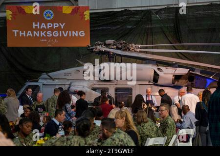 Norfork, United States of America. 19 November, 2023. Left to right: U.S. President Joe Biden, chef Robert Irvine and First Lady Jill Biden serve Thanksgiving meals to members of the armed forces and their families during a Friendsgiving dinner at Naval Station Norfolk, November 19, 2023 in Washington, D.C. The meal was hosted by celebrity chef Robert Irvine Credit: MC2 Anderson Branch/US Navy Photo/Alamy Live News Stock Photo