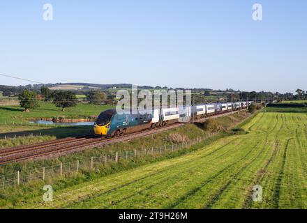 Avanti west coast class 390 Pendolino train passing the countryside at Plumpton (north of Penrith) on the west coast mainline in Cumbria Stock Photo