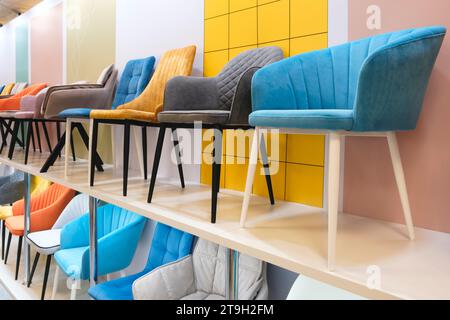 Many different chairs and armchairs on display in a furniture store ...