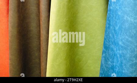 Mix colorful hanging vertical stripe leather on the rack. Texture of multicolored leather close up. Stock Photo