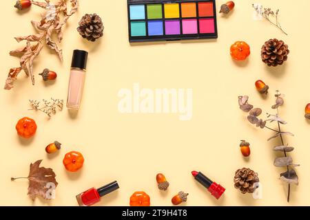 Frame made of different makeup products and autumn decor on beige background Stock Photo