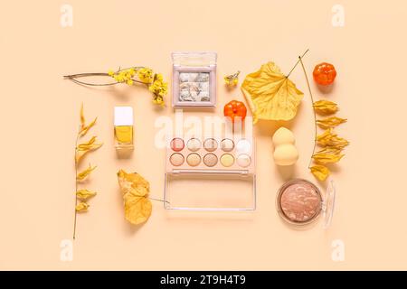 Autumn composition with makeup products on beige background Stock Photo