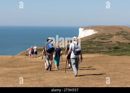 Hikers walking along Tennyson Down on the Isle of Wight, England Stock Photo