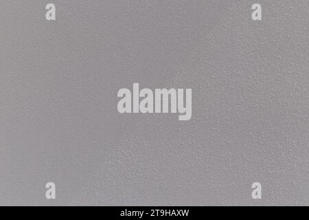 Plastered concrete or stone stucco wall painted in white, front view. Abstract high resolution full frame textured background with copy space. Stock Photo