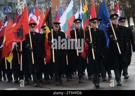 Vilnius, Lithuania. 25th Nov, 2023. Lithuania's military officers march with NATO countries' flags during a military parade on Armed Forces Day in Vilnius. Armed Forces Day honours the restoration of the Lithuania armed forces on November 23, 1918. The military parade commemorating the holiday is being held this year on November 25 in Vilnius. Both Lithuanian military and allies from NATO countries took part in the parade, totaling about 1,400 people and 100 pieces of military equipment. Credit: SOPA Images Limited/Alamy Live News Stock Photo