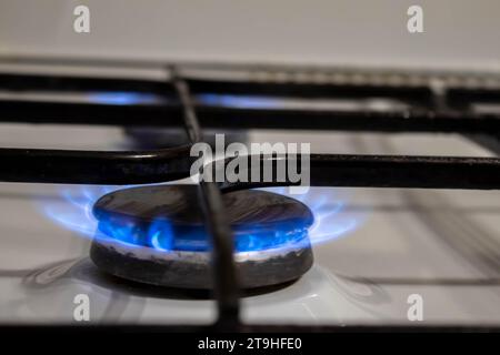 gas pipe with open yellow valve and burning gas burner, double exposure of natural gas use. Stock Photo