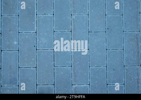 View of the paving slabs. The tiles are laid in even rows, top view. Gray paving slabs, diagonal view Stock Photo